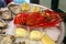 Dish of fresh seafood, lobster with oysters with lemon and sauce