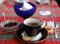 Dish with jam, cup with coffee and cookies, blue cup with ice cream, glass with water, teaspoon