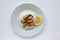 Dish with mussel risotto on white background. Top view of white rice with seafood and lemon slice. Copy space. Healthy eating