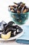 Dish of mussel shells and bowl of mussels
