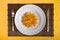 Dish with orange flower on bamboo board