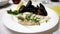 A dish with sea bream fillet and mussels with oil and lemon