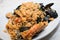 A dish of seafood rice pics, with mussels, clams, shrimp, musse