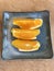 Dish of slice bright oranges.
