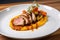 dish of sous-vide pork tenderloin, paired with creamy polenta and roasted vegetables