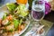 Dish of Thai style salad with cutlery, glass of water