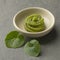 Dish with traditional Japanese horseradish paste and wasabi leaves