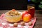 Dish of traditional Slavic treat on Christmas Eve. Christmas tree, apples, walnuts, glass of compote on a patterned tablecloth. B