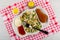 Dish with vegetable, cutlet, mayonnaise, ketchup, fork, salt and