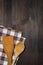 Dishcloth, wooden spoons, wooden background, vertical top view
