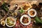 Dishes beef ribs bruschetta fish on wooden table at hunter restaurant cafe daylight sunlight