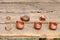 Dishes of copper on a wooden table. Bronze things from vintage patterns. Cups, rings, handmade copper jewelry, retro style