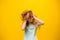disheveled, kid girl scratch hair on the yellow background,