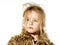 Disheveled preschooler girl with long hair dressed in fur coat