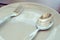 Dishware set on wood table with plate, spoon and fork