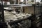 dishwasher in busy cafeteria, with plates and glasses being washed and dried