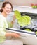 Dishwasher. Young woman doing Housework