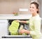 Dishwasher. Young woman doing Housework