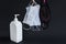 Disinfectant spray bottle on black with washable,fabric and surgical medical masks.