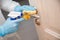 Disinfection and cleaning door handles of house from infection with virus and microbes in biochemical suit. Coronavirus