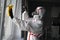 Disinfection of coronavirus in the apartment. People in protective suits make professional cleaning of the room from viruses and