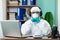 Disinfection man with special white suite listening music