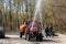 Disinfection in Moscow. Irrigation tractor irrigates the road with detergent composition.