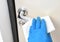 Disinfection in public places, the fight against the virus, coronavirus.Worker`s hand wipes the door handles. A maid or housewife