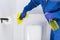 Disinfection of surfaces in the toilet room by the cleaning service, close-up