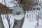 A disk for repelling birds on a tree in winter