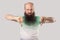 Dislike. Portrait of dissatisfied middle aged bald man with long beard in light green t-shirt standing thumbs down and looking