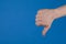 Dislike! Thumbs down!, Man showing a thumb down isolated on blue background.