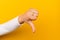 dislike thumbs up on a yellow paper background disapproving and disapproving gestures disagreeing with what you don\'t like