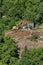 Dismantling of buildings in the park with an excavator. Destroy of an illegally built old building in nature - Moscow, Russia,