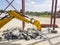 Dismantling of reinforced concrete with an excavator using a hydraulic hammer. Rigging of reinforced concrete using heavy