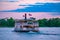 Disney Ferry boat in blue lake on colorful sunset background at Walt Disney World  2