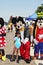 Disney Mickey Mouse, Goofy and Minnie Mouse with small girl at festival