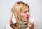 Dispenser bottle. Sick woman spraying medication into nose. Treating common cold or allergic rhinitis. Cute woman
