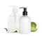 Dispensers with liquid soap, freesia flowers and limes on white background