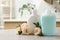 Dispensers of liquid soap and roses on light grey table in bathroom, space for text