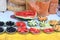 Display of cut fruits like watermelon, raw mango, berries, pineapple served in leaf bowls