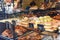 Display window of a bakery and pastry shop with assortment of different kinds of freshly baked artisan food