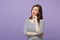 Displeased disgusted young brunette woman in casual striped clothes posing isolated on violet purple background studio