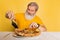 Displeased gray bearded man tasting italian pizza with cheese isolated on yellow studio background.