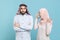 Displeased irritated couple friends arabian muslim man wonam in keffiyeh kafiya ring igal agal hijab clothes isolated on