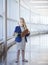 Displeased little girl holding dollars in shopping mall