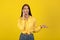 Displeased Millennial Woman Talking On Mobile Phone Over Yellow Background