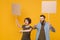 Displeased protesting two people guy girl hold protest signs broadsheet blank placard on stick showing thumbs down