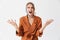 Displeased screaming young blonde pretty woman wearing silk scarf posing isolated over white wall background