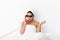 Displeased shocked woman with towel on head lies in bed under blanket isolated over white wall background wearing sunglasses
